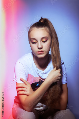 Teen girl in stylish clothes. Trend photos in 90s style. Toning photos with highlights.