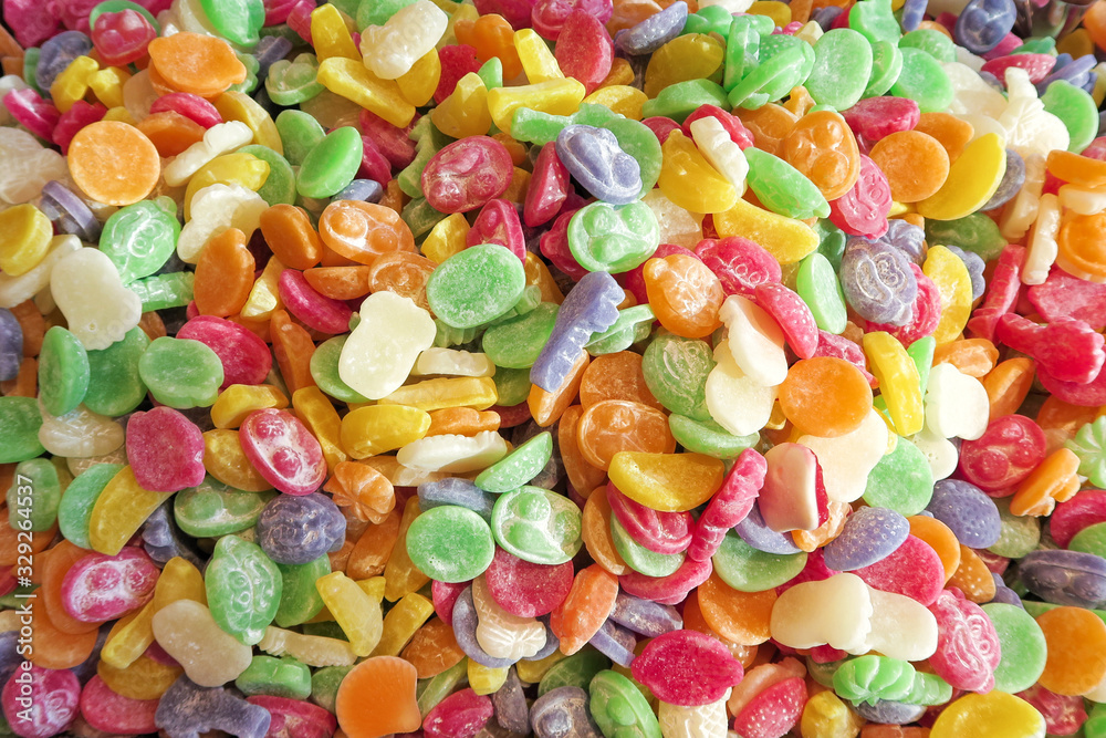 Flat top view of multicolored chewing marmalade. Texture of dessert marmalade with a sharp and sweet-sour taste. Jelly candies in bright red, yellow, green and orange colors. Flat top view of multicolored chewing marmalade. Texture of dessert marmalade with a sharp and sweet-sour taste. Jelly candies in bright red, yellow, green and orange colors.