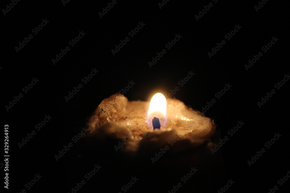 burning candle on black background burning candle on black background