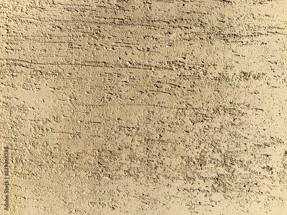 Obraz premium Scratched wall surface covered by decorative stucco. Painted putty. Decorative construction materials. Abstract background texture pattern with copyspace