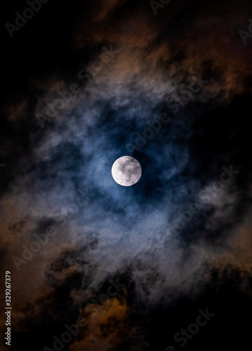 Super Moon on a dark, cloudy sky on March, 9th 2020