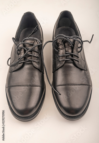 A pair of black leather boots on a white background. Close up.