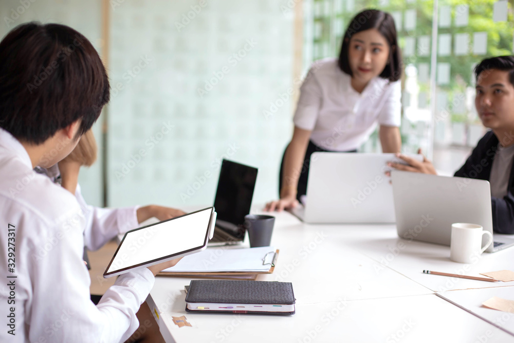 A team of Asian business owners are teaching job for new people using computers. New employees are being trained by business owners. A team of Asian business owners are teaching job for new people using computers. New employees are being trained by business owners.