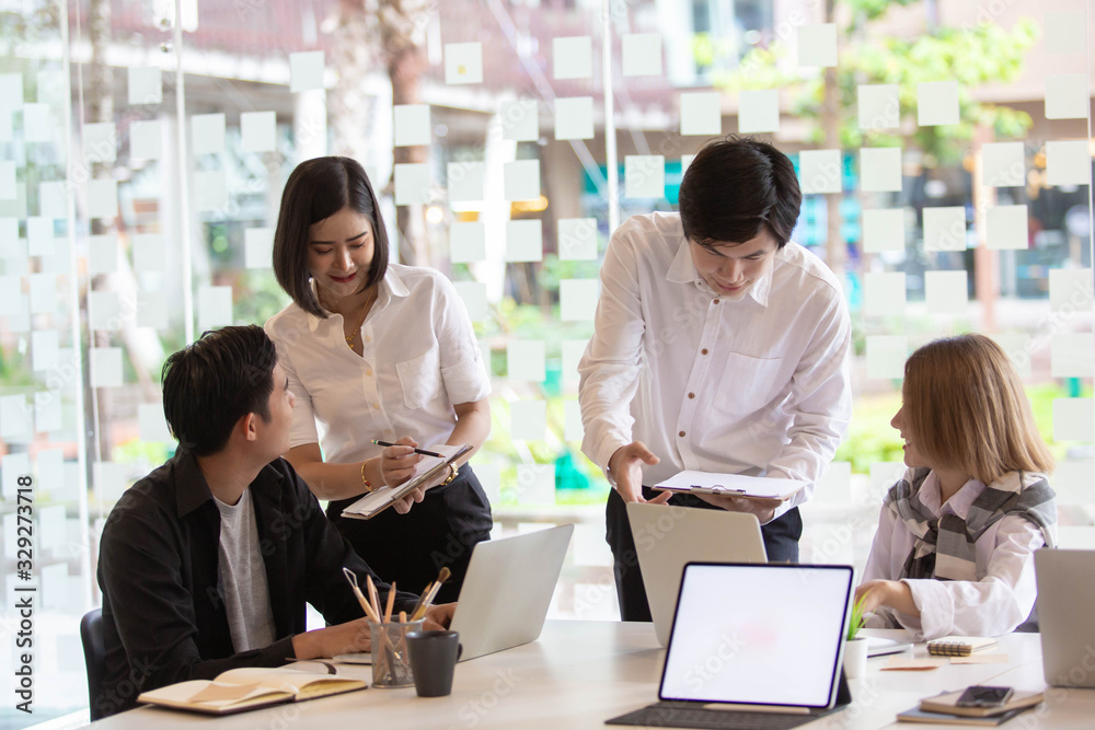 A team of Asian business owners are teaching job for new people using computers. New employees are being trained by business owners. A team of Asian business owners are teaching job for new people using computers. New employees are being trained by business owners.