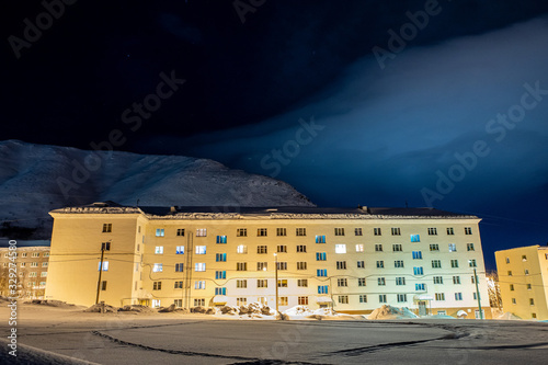 Cloudy sky over a mountain town with night lights.