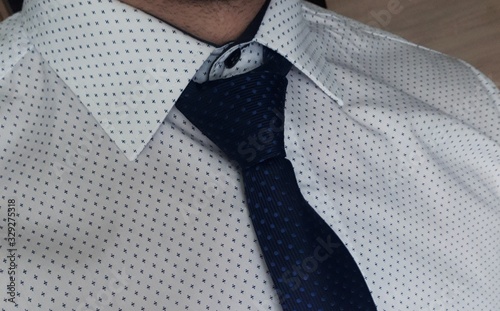 Male white shirt with blue tie close up