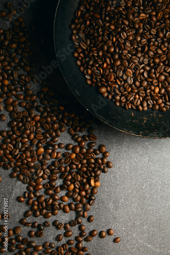 Vertical top view of roast coffee pan and beans on ardesia table © CreativePhotography