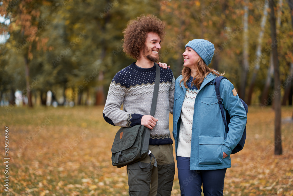 Holidays with friend. Young couple walking together in the park. Holidays with friend. Young couple walking together in the park.