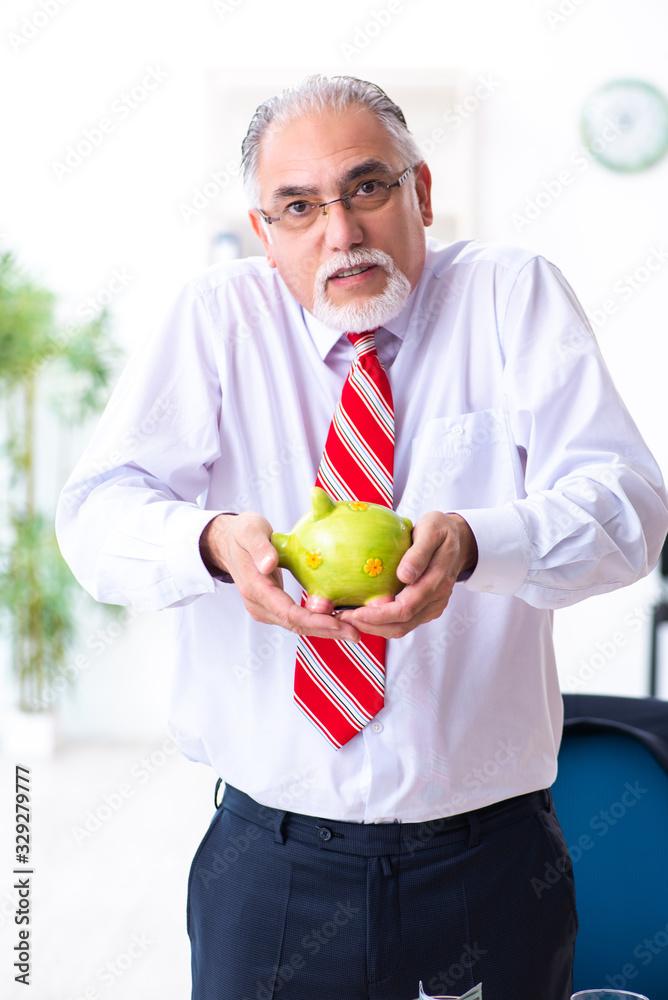 Fototapeta premium Old male accountant in budget planning concept