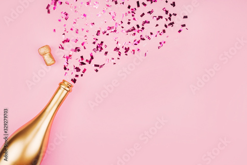 Bottle of champagne and confetti. 
