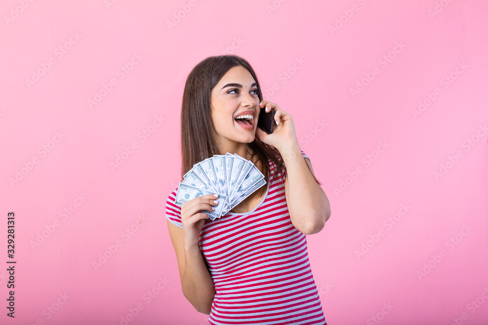 Image of a shocked surprised screaming young pretty woman posing isolated over pink wall background using mobile phone holding money. Image of a shocked surprised screaming young pretty woman posing isolated over pink wall background using mobile phone holding money.