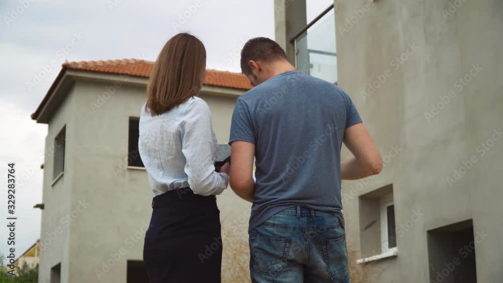Worker speaking with project manager developer about house project. Worker speaking with project manager developer about house project.
