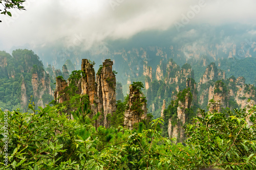 Panorama of mountain range (Yubi Feng Peaks) with low clouds and fog  in Yellow Stone Stronghold (Huangshi Zhai) in Yuanjiajie Scenic Area , Zhangjiajie National Park, China