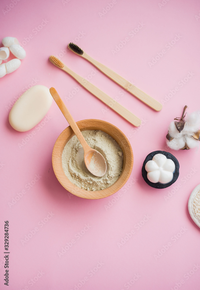 Cosmetic bath salt, grape gomaj for the face, coffee scrub for the body on a pink background.
