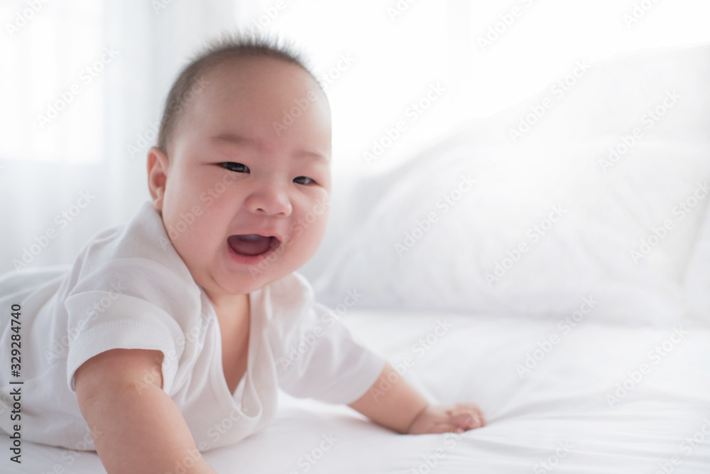 newborn child relaxing in bed. adorable baby boy in white sunny bedroom. nursery for young children. textile and bedding for kids. family morning at home. six month. childhood and baby care concept. newborn child relaxing in bed. adorable baby boy in white sunny bedroom. nursery for young children. textile and bedding for kids. family morning at home. six month. childhood and baby care concept.