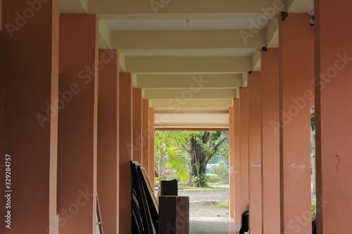Hallway room with a lot of supporting poles on the right and left