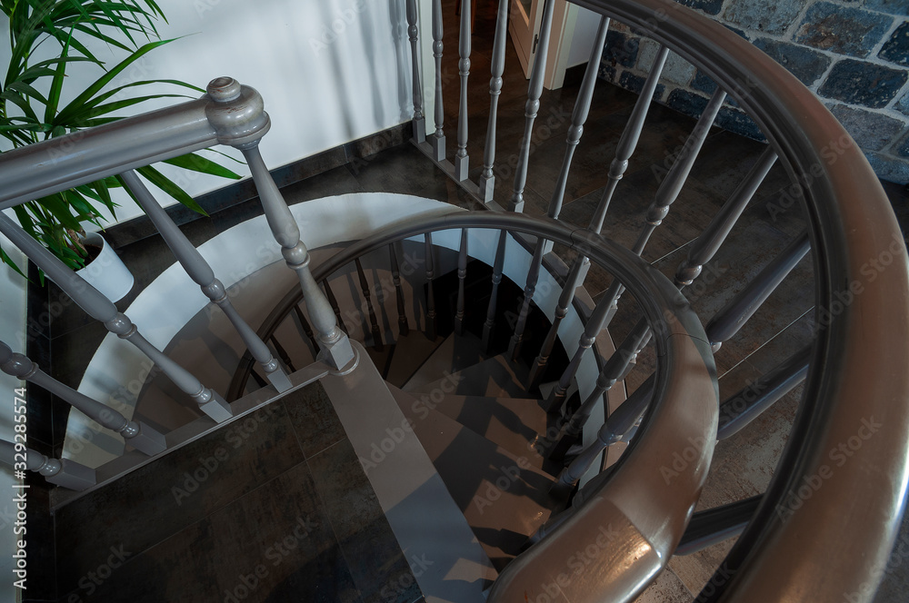 Classic spiral staircase with wooden steps and railing