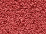 Red background facade plaster . Monolithic plaster decorative backdrop. Single layer scraped cement plaster wallpaper. Exterior building structure backdrop. Silica sand cement wall plaster