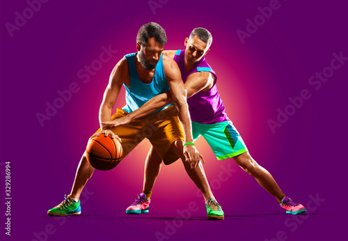 colourful professional basketball players isolated over purple background