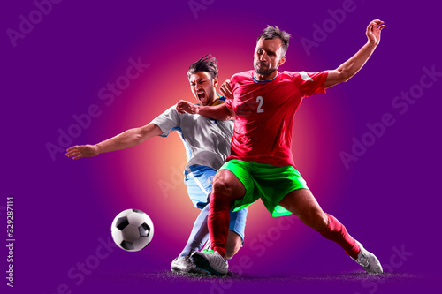 colourful professional soccer players isolated over purple background © 103tnn