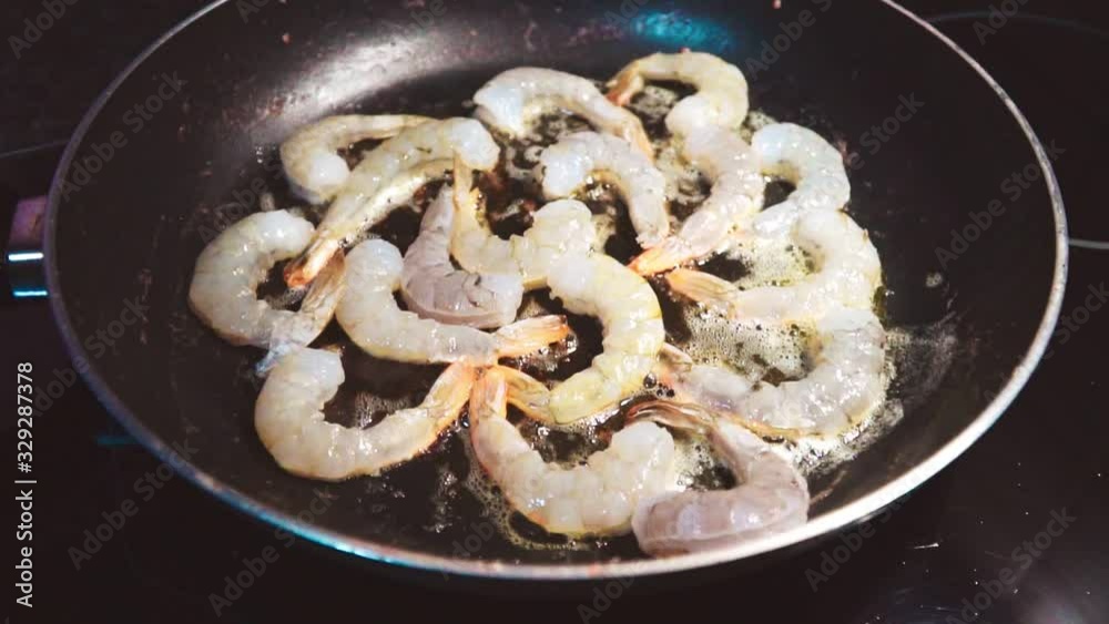 King prawns are fried in a pan. King prawns are fried in a pan.