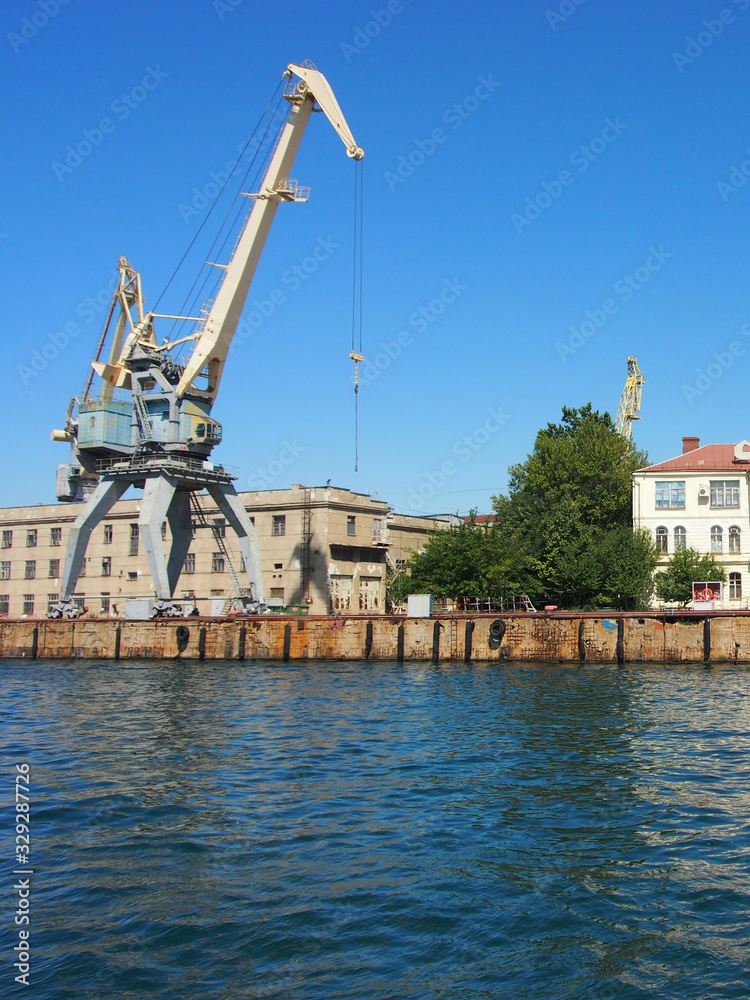 Portal, transshipment crane on the pier of the sea, cargo port. Terminal sea, cargo port.