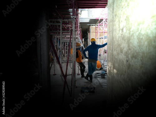 worker is rest in construction site, photo is film grain style and black space area for input text