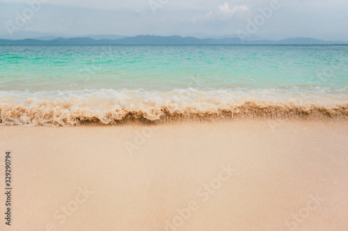 Seascape view with beautiful ocean wave on sandy beach.