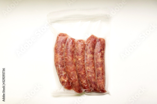 Chinese sausage in vacuum package isolated on white background.