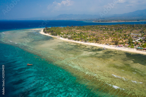 Aerial drone view of a beautiful tropical beach and coral reef on a small island (Gili Air, Indonesia)