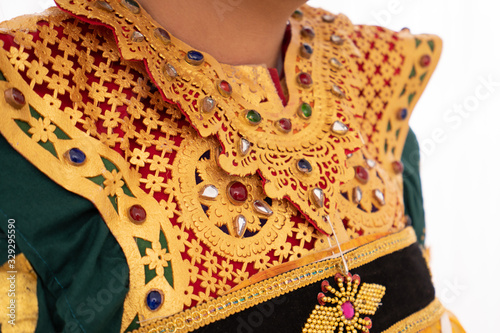 Cropped of chest portrait of Balinese dancer wear traditional clothing with Hindu cultural accessory symbols