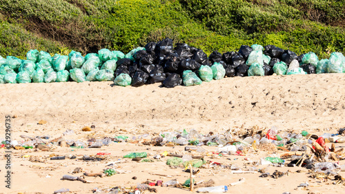 On a beach at Umkomaas in South Africa, plastic pollution that washed out by the incoming tide, was collected in plastic bags and stacked on the beach for removal. photo