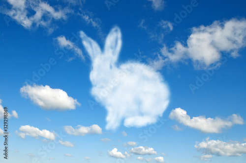 Fototapeta Naklejka Na Ścianę i Meble -  Shape of fluffy cloud Easter bunny on a cloudy sky blue background.