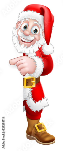 Santa Claus Christmas cartoon character peeking around the side of a sign background pointing at it with copyspace.