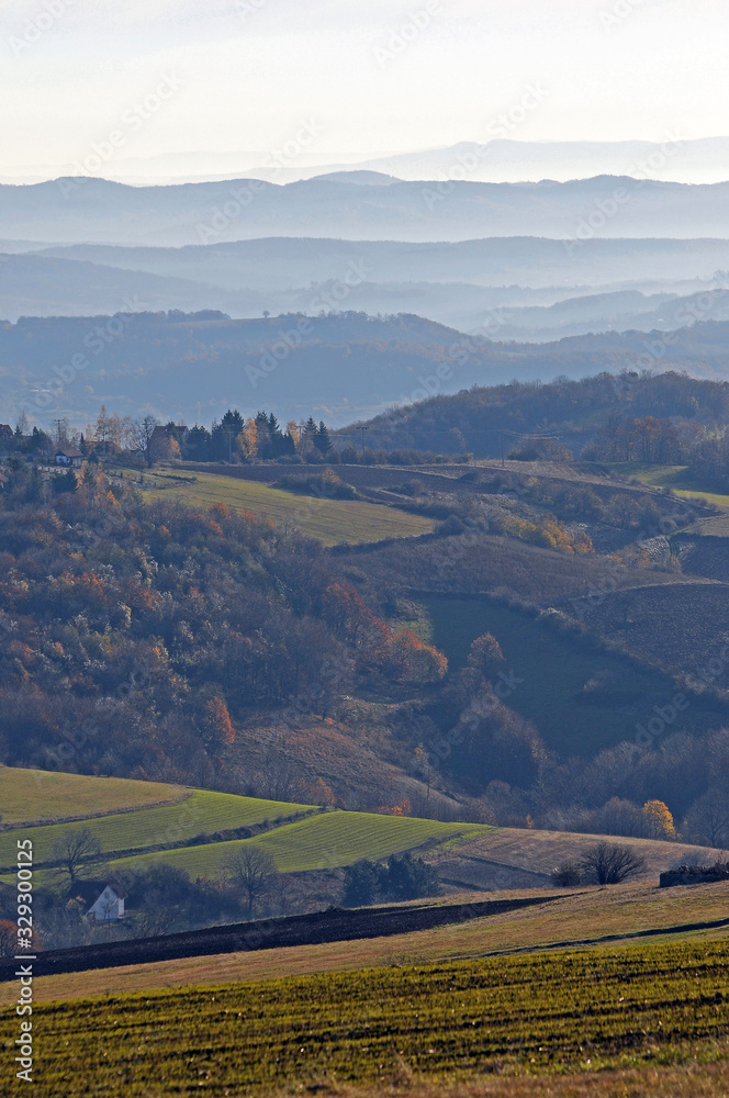 Naklejka premium Distant hills in the haze. Beautiful mountain scenery. Mystical rural scenes. Scattered houses of mountain villages. Beautiful nature background.