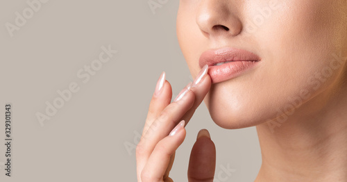 Unrecognizable Girl Touching Lips Over Beige Studio Background, Panorama, Cropped photo