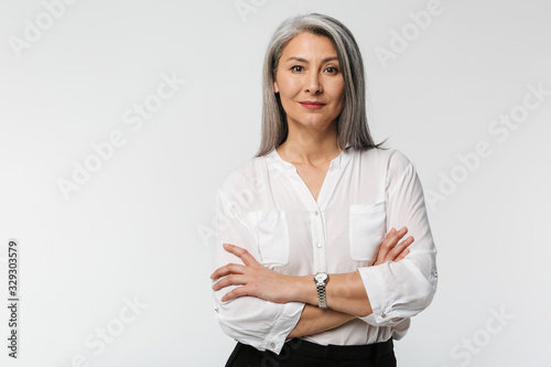 Image of adult mature woman with long gray hair wearing office clothes
