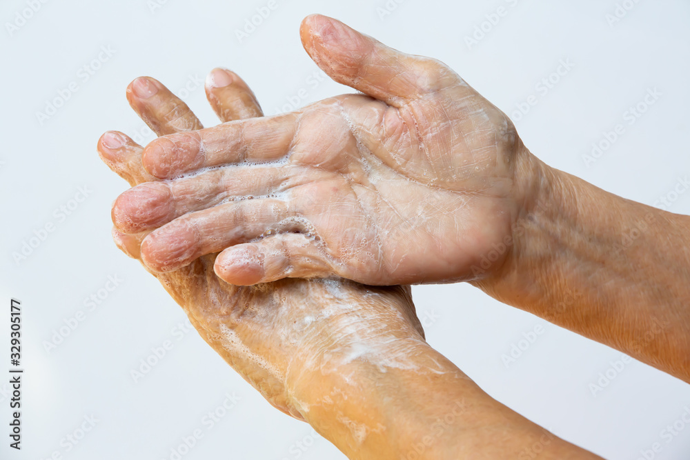 Senior woman's hands washing her hands using soap foam in step on white background, Close up & Macro shot, Selective focus, Prevention from covid19, Bacteria, Healthcare, step by step wash hand Senior woman's hands washing her hands using soap foam in step on white background, Close up & Macro shot, Selective focus, Prevention from covid19, Bacteria, Healthcare, step by step wash hand