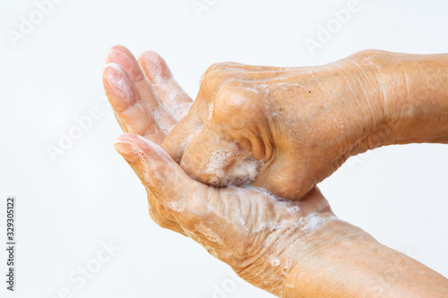 Senior woman's hands washing her hands using soap foam in step 4 on white background, Close up & Macro shot, Selective focus, Prevention from covid19, Bacteria, healthcare concept, 7 step wash hand