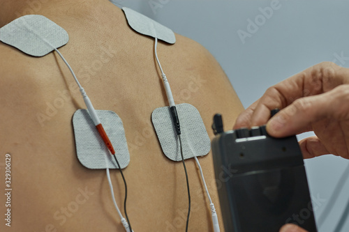 Фотография Electro stimulation in physical therapy to a young woman