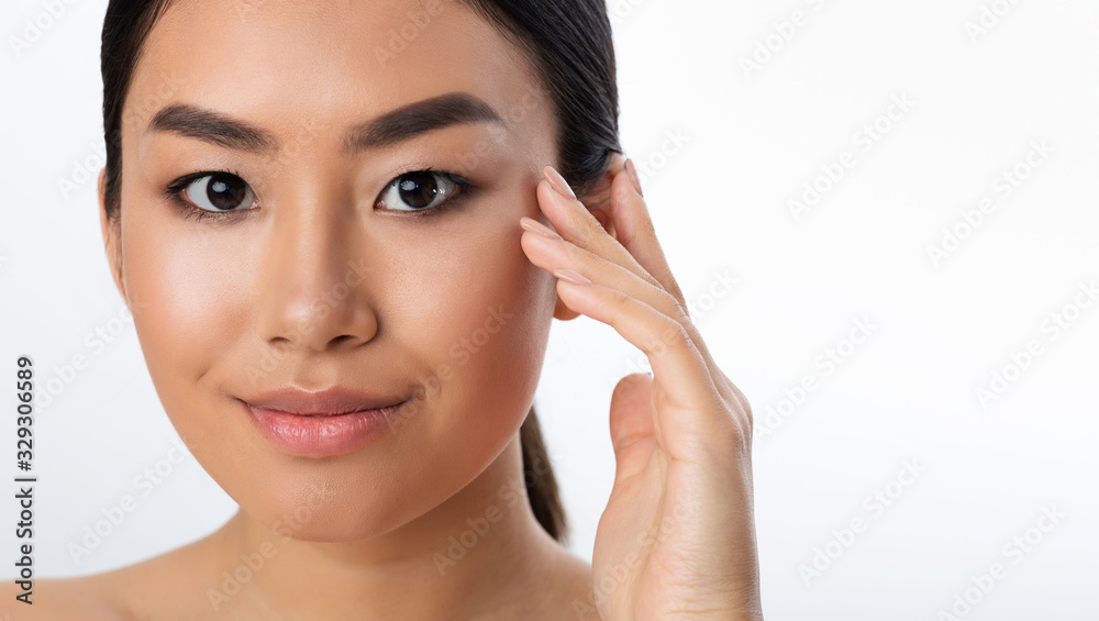 Asian Girl Touching Smooth Skin Posing Over White Background Asian Girl Touching Smooth Skin Posing Over White Background