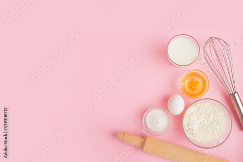 Frame of food ingredients for baking on a gently pink pastel background. Cooking flat lay with copy space. Top view. Baking concept.