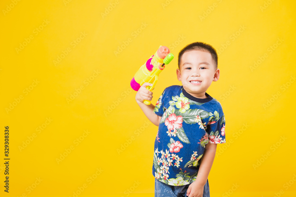 little children boy so happy in Songkran festival day holding water gun little children boy so happy in Songkran festival day holding water gun