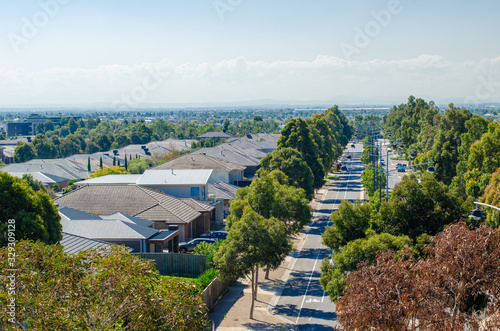 Obraz na plátně Aerial view of residential houses by a main road in Melbourne's suburb