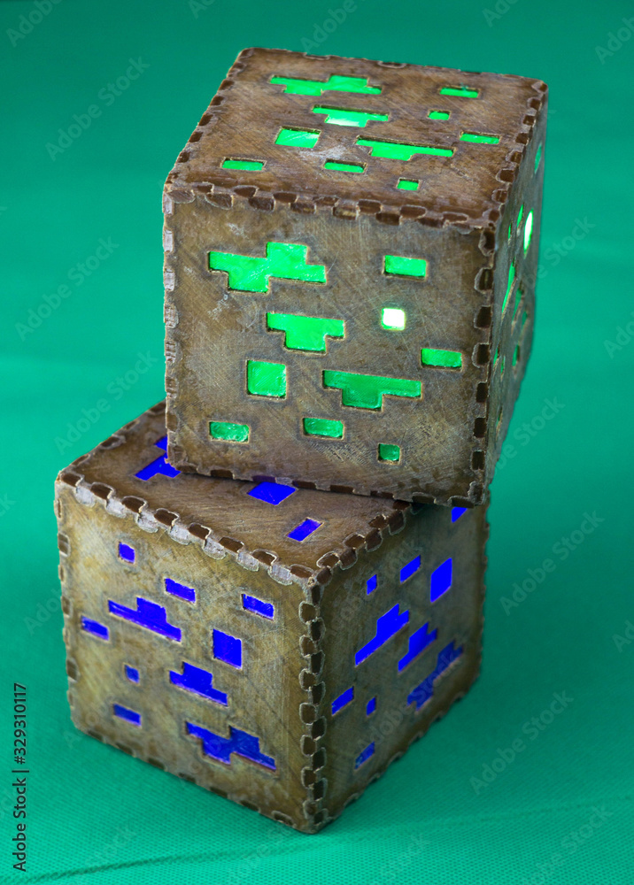 Naklejka premium Minecraft cubes made of plastic. Two brown minecraft cubes with glowing Windows