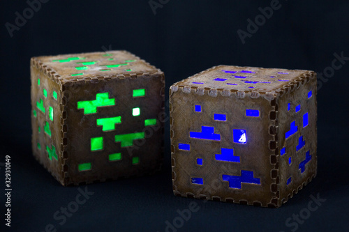 Minecraft cubes made of plastic. Two brown minecraft cubes with glowing Windows photo