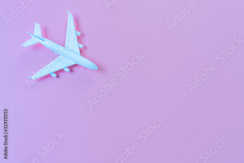 Top view of model plane, airplane on pink color background, travel concept. Flat lay , copy space