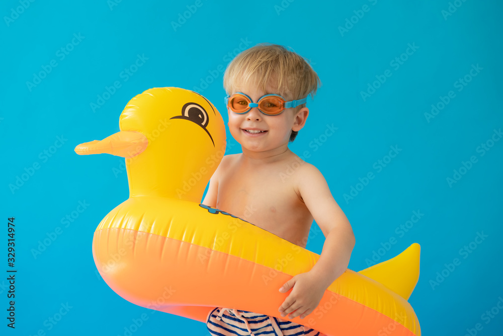 Fototapeta Portrait of happy child with yellow rubber duck