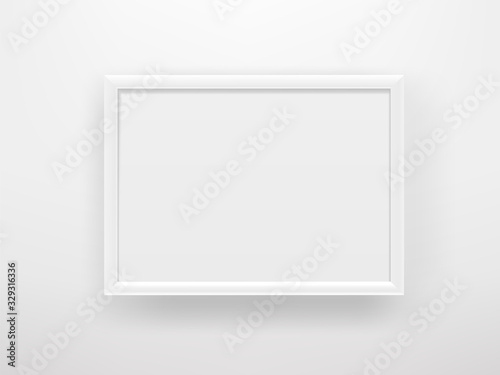 Empty white frame on a white wall. Horizontal composition