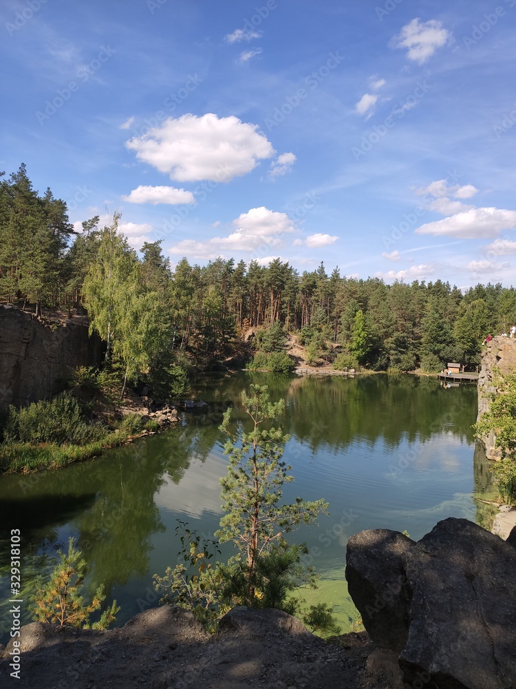Obraz premium quarry with a lake in the forest